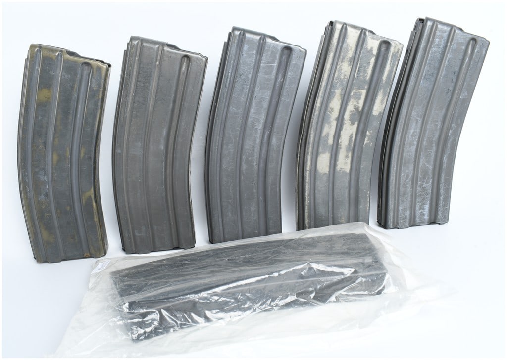 A Group of 6 Center Industries and Heckler & Koch AR-15 Magazines: A group of 6 steel firearm magazines designed for the 5.56x45mm NATO caliber AR-15 and M16 platforms. The collection consists of five loose magazines and one unit in original factory packaging. The