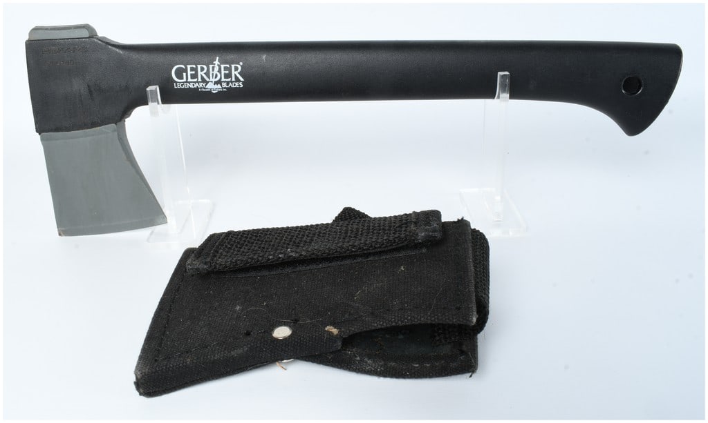 Gerber Back Paxe II Hatchet with Sheath: This Gerber Back Paxe II hatchet is a utilitarian tool featuring a grey-finished steel head and a black glass-filled nylon composite handle. The head is stamped with the FISKARS FINLAND mark, while