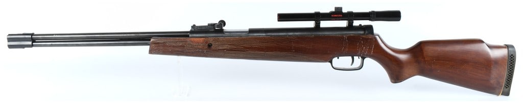 Chinese Shanghai Under-Lever Air Rifle with Simmons Scope Late 20th/Early 21st Century: This is a Chinese-manufactured air rifle, likely an under-lever cocking model, constructed of dark-stained wooden stock and black finished metal components. The receiver is prominently marked with the