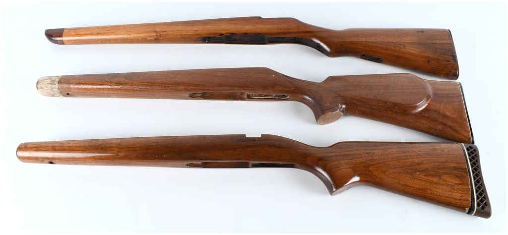 Vintage Hardwood Rifle Stocks Assortment Lot of Three Sporter Style Accessories: A lot consisting of three separate wooden rifle stocks constructed of brown hardwood, likely intended for various bolt-action or semi-automatic sporting rifles manufactured during the mid-20th century