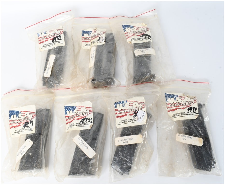 Seven U.S.A. Magazines Aftermarket Smith & Wesson 9mm 13-Round Magazines: A collection of 7 aftermarket handgun magazines manufactured by U.S.A. Magazines, designed for Smith & Wesson 9mm firearms. Each magazine is constructed of dark-finished metal and features a 13-round