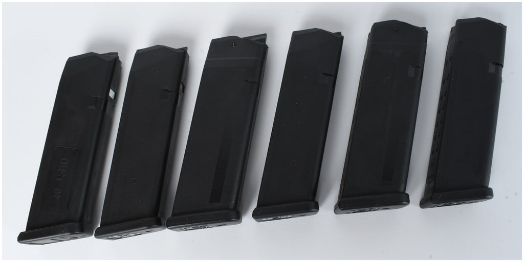 A Set of Five Glock Factory Handgun Magazines: A set of five Glock factory handgun magazines in various calibers, including 9mm, .40 S&W, and .45 ACP. The magazines are constructed of black polymer with internal steel reinforcements and feature st