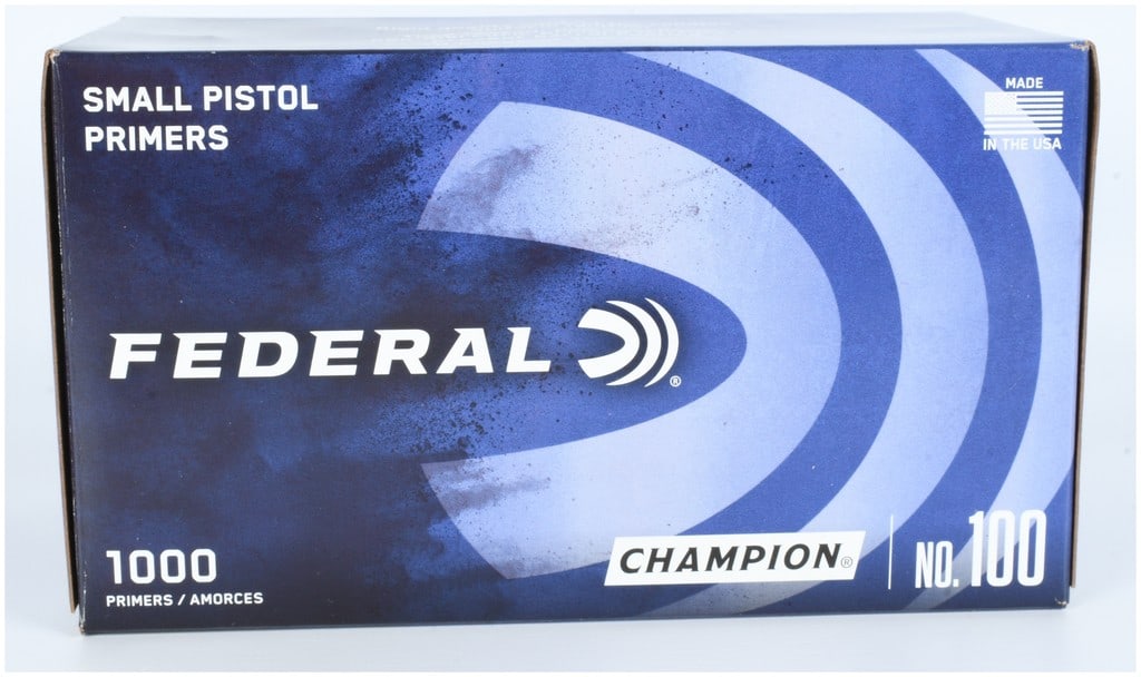 1000 Federal Champion No. 100 Small Pistol Primers: A collection of 1000 Federal Champion No. 100 small pistol primers. The lot is presented in its original commercial packaging, featuring a master blue and white cardboard box that contains multiple in