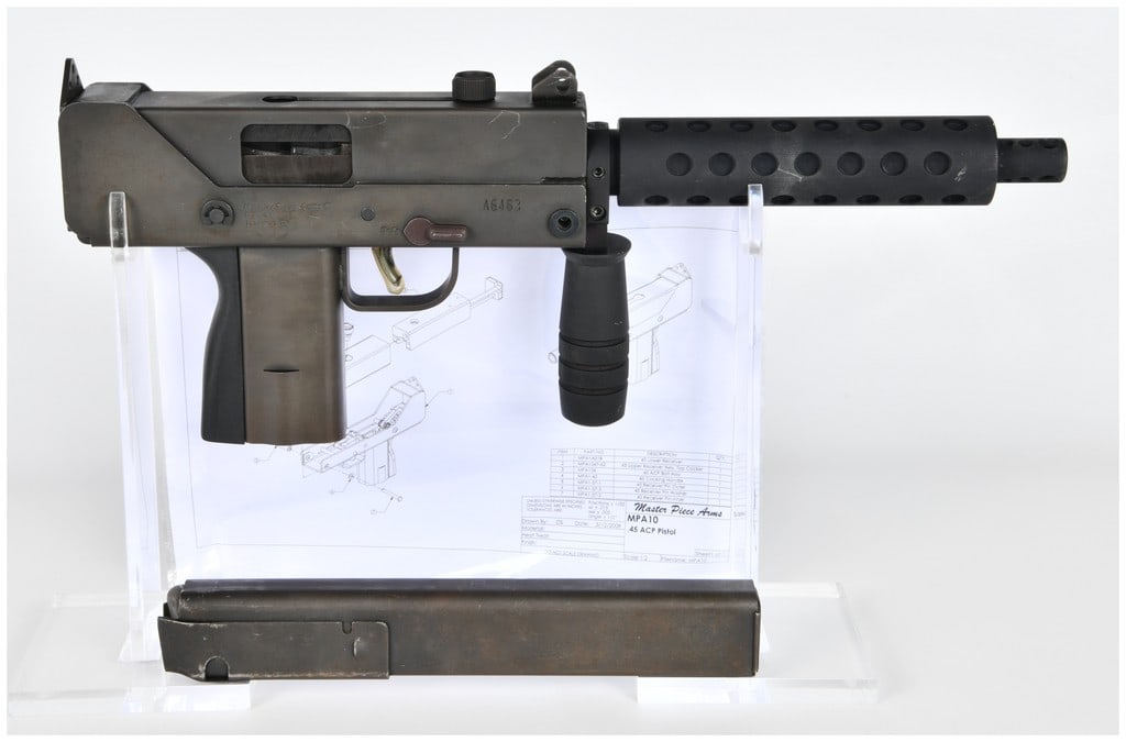 MasterPiece Arms MPA10 Semi-Automatic Pistol .45 ACP: This MasterPiece Arms MPA10 is a semi-automatic pistol chambered in .45 ACP featuring a stamped steel receiver with a dark matte gray finish. The firearm is equipped with a barrel shroud featuring cir