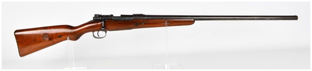 Geha Mauser Shotgun Conversion Bolt Action Shotgun 12-Gauge: This is a Geha Mauser shotgun conversion, a post-World War I civilian modification of a military Mauser bolt action rifle. Chambered for 12-gauge shells, this firearm features a long, tapered smoothbo