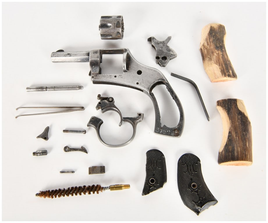 Harrington & Richardson Young America Double Action Revolver .22 Rim Fire for Parts/Repair: This lot consists of a disassembled Harrington & Richardson Young America Double Action revolver chambered in .22 Rim Fire, offered as a parts gun. The assembly includes a frame with an integral octag