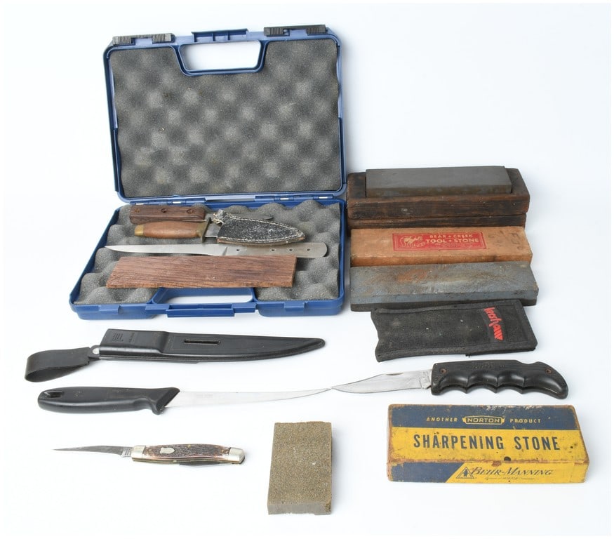 A Collection of Knives and Sharpening Stones Including Kershaw, Camillus, and Fiskars: This collection includes an assortment of folding and fixed-blade knives, knife-making materials, and sharpening equipment. The group features a Kershaw lockback folding knife with a stainless steel b