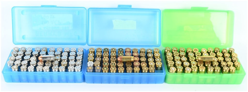 A Lot of 150 Rounds of Mixed Manufacturer .380 ACP Ammunition: This lot consists of 150 rounds of .380 ACP ammunition presented in three plastic flip-top storage cases, including two blue and one green container. The collection features a diverse array of headsta