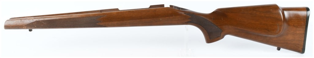 Remington 700 ADL Long Action Bolt Action Rifle Stock: This is a factory-style wooden stock designed for a Remington 700 ADL long action bolt-action rifle. Constructed from finished hardwood, likely walnut, the stock features a Monte Carlo-style comb with