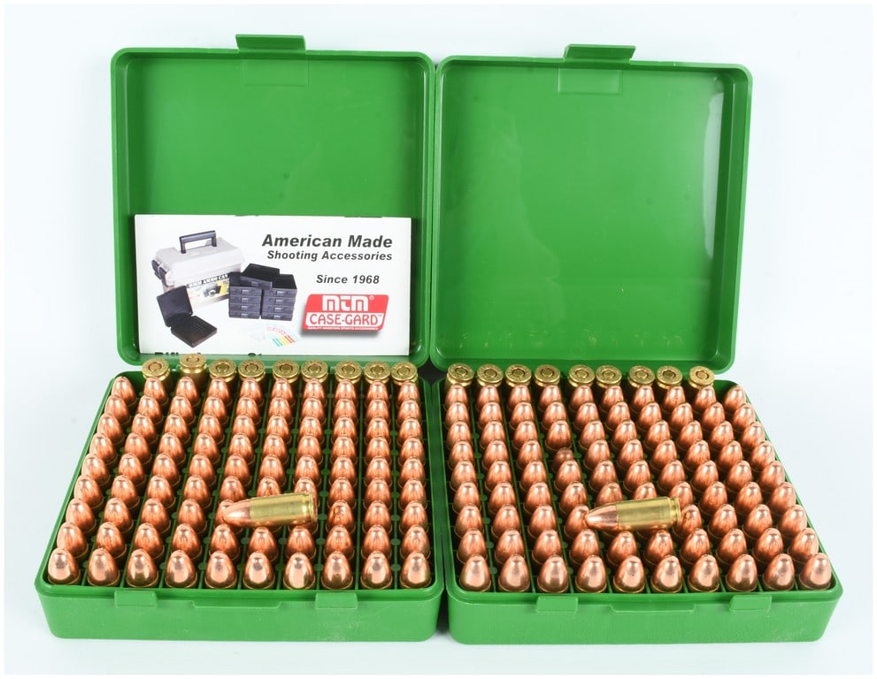 Winchester 9mm Luger Ammunition 200 Rounds: A lot of 200 rounds of Winchester 9mm Luger ammunition, presented in two green MTM Case-Gard 100-round flip-top boxes. The ammunition is configured with brass casings and copper-jacketed round-nose pr