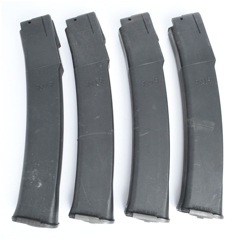 A Lot of 4 Kalashnikov USA KP-9 Magazines 9x19mm: This lot consists of four curved magazines designed for the Kalashnikov USA KP-9 and KR-9 platforms, chambered for 9x19mm Parabellum. Each magazine features a durable matte black polymer body with a r