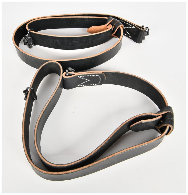 A Pair of Montana 1" Black Leather Slings: This lot comprises two Montana 1" black leather slings. Each sling is crafted from heavy-duty black bridle leather and features a sliding loop system for adjustment. The edges of the straps are finish