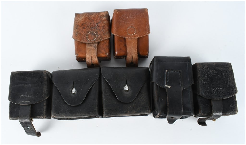 A Collection of Seven Pieces of Swiss Military Leather Ammunition and Equipment Pouches: A collection of seven pieces of mid-20th-century Swiss military leather equipment, primarily consisting of ammunition and utility pouches manufactured circa 1941. This group features three black pebbl