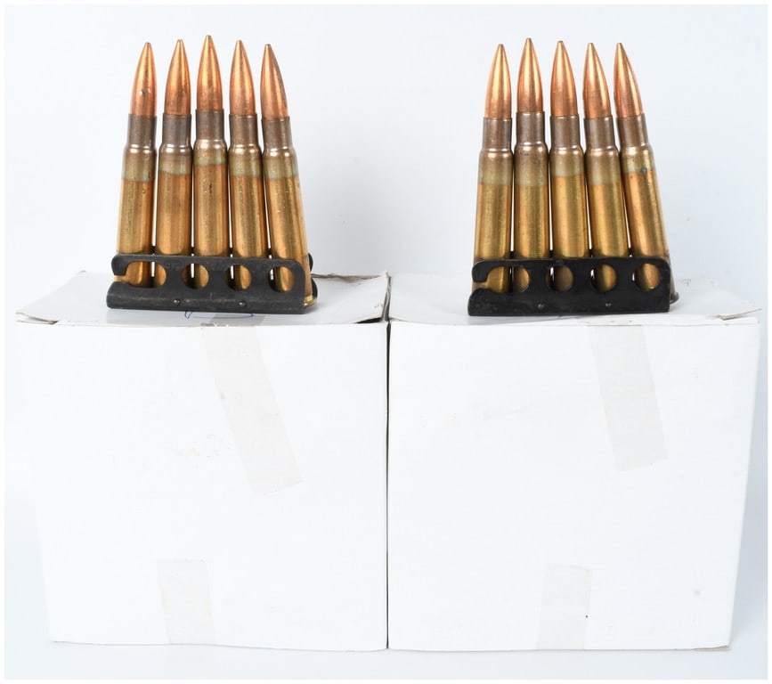 A Lot of 70 Rounds of .303 British Ammunition on Stripper Clips: This lot consists of seventy rounds of .303 British caliber military surplus ammunition mounted on fourteen individual metal stripper clips. The cartridges are organized within two plain white cardboa