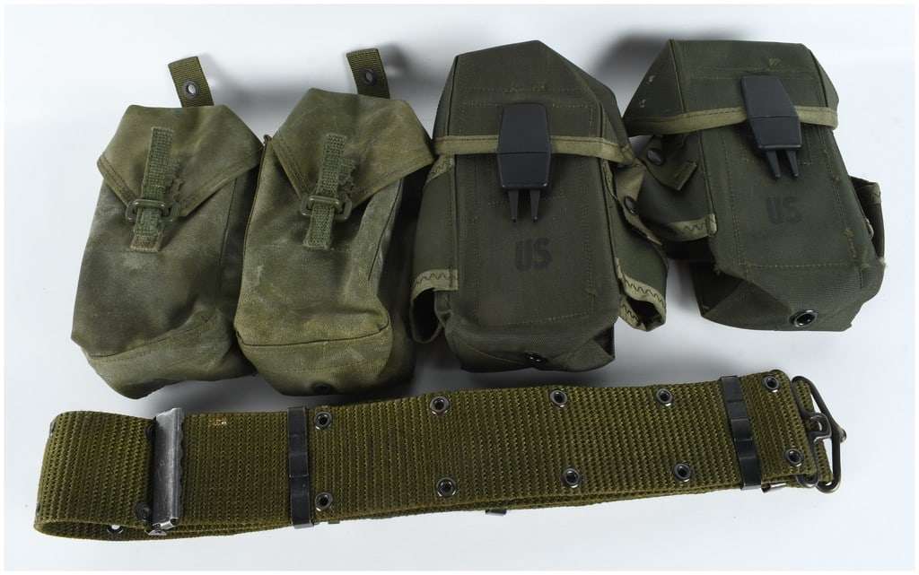 A Collection of US Military Ammunition Pouches and Individual Equipment Belt: This collection of United States military load-bearing equipment consists of field gear components spanning from the Vietnam War through the Cold War era. Included are M1956 Small Arms Ammunition Pouc