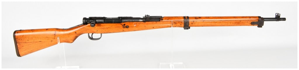 Nagoya Arsenal Type 99 Arisaka Bolt Action Rifle 7.7x58mm with 25.9 Inch Barrel: This is a Japanese Type 99 Arisaka bolt action rifle manufactured at the Nagoya Arsenal and chambered in 7.7x58mm. The rifle features a 25.9 inch barrel fitted with a hooded front sight and a folding 