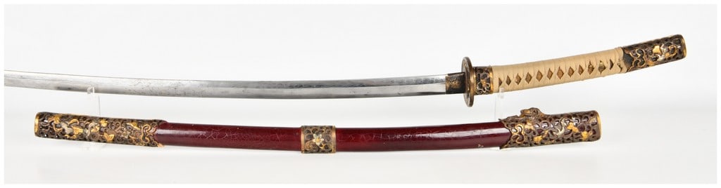 Modern Japanese Style Pattern Welded Steel Katana and Scabbard Signed Shimoyama Shinji: This modern Japanese-style sword (katana) is constructed with a pattern-welded steel blade featuring a prominent wavy grain pattern. The blade includes a defined ridge line and tip. The brass-toned me