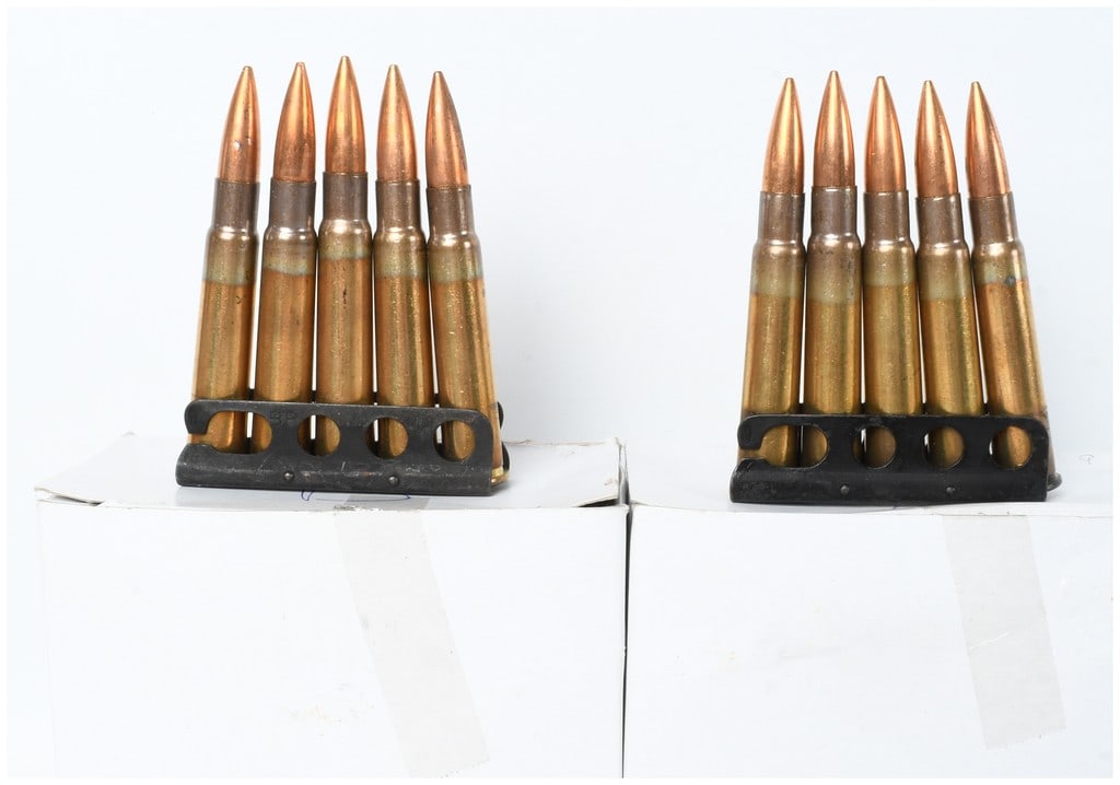 A Lot of 85 Rounds of .303 British Ammunition on Stripper Clips: A lot of eighty-five rounds of .303 British ammunition, organized on multiple blackened steel stripper clips each containing five rounds. The cartridges feature brass cases with prominent annealing at