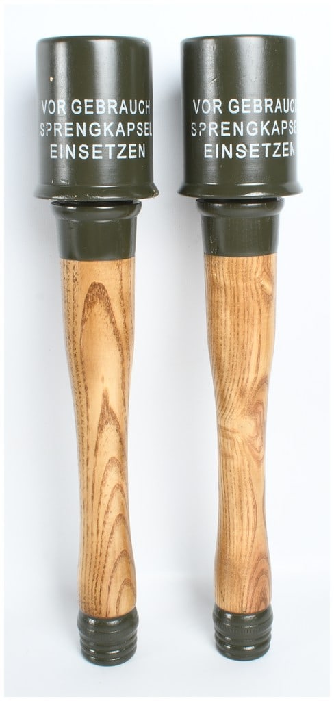 A Pair of Inert Reproduction German WWII M24 Stielhandgranate Stick Grenades: A pair of inert Model 24 Stielhandgranate (stick grenades), the standard-issue hand grenade of the German Wehrmacht during World War II, frequently referred to as potato mashers. These items are conte