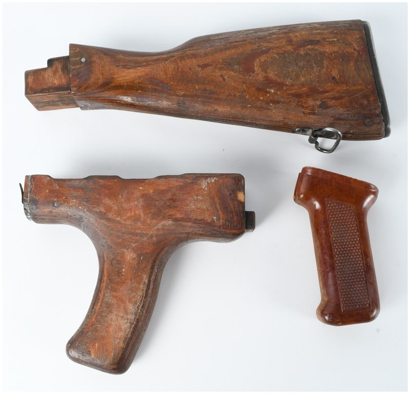 A 3-Piece Romanian PM md. 63 Laminated Wood and Bakelite Rifle Furniture Set: This 3-piece furniture set is comprised of Romanian military surplus components for the PM md. 63 (Pistol Mitraliera model 1963), a licensed variant of the Soviet AKM. The set includes a fixed-style b