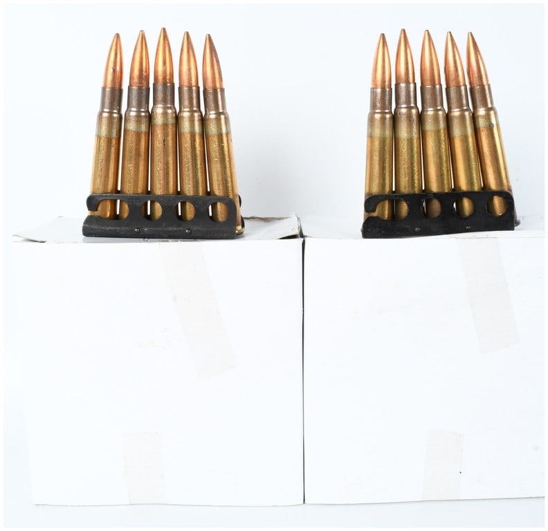 A Lot of 45 Rounds of Hirtenberger .303 British Ammunition: This lot consists of 45 rounds of .303 British centerfire rifle ammunition manufactured by Hirtenberger Patronenfabrik of Austria. The cartridges are organized on nine 5-round black polymer or steel s