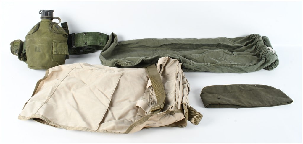 A Collection of US Military Personal Field Equipment Including Canteen and Satchel Charge Bag: This collection features several pieces of United States military personal field equipment from the mid-to-late 20th century. The assortment includes a standard one-quart olive drab plastic canteen wi