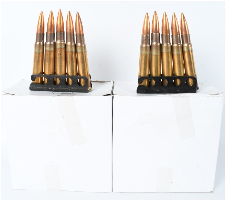 A Lot of 85 Rounds of Hirtenberger .303 British Ammunition: This lot features a collection of 85 rounds of .303 British ammunition manufactured by Hirtenberger Patronenfabrik of Austria. The cartridges are organized on black-finished steel stripper clips, with