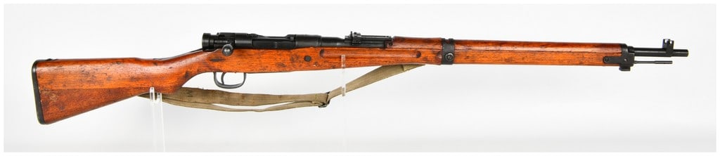 Nagoya Arsenal Type 99 Bolt Action Short Rifle 7.7x58mm Arisaka with 26 Inch Barrel: This Japanese Type 99 Arisaka bolt-action short rifle is chambered in 7.7x58mm and configured for military service. The rifle features a 26 inch barrel with a blued finish that shows significant thinn