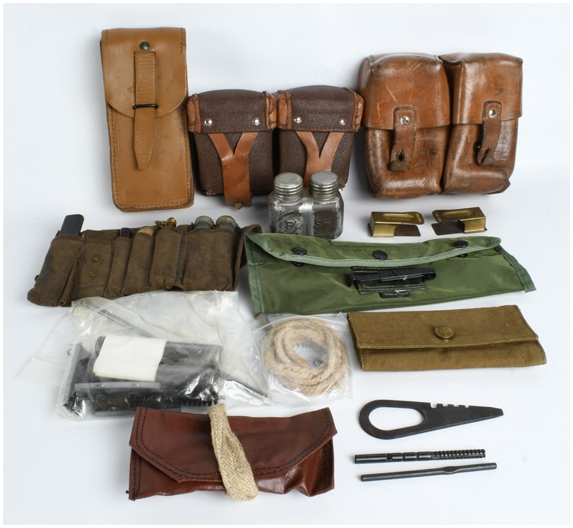 A Collection of US and European Military Field Gear, Weapon Maintenance Kits, and Commemorative: This lot features an assortment of military field equipment, weapon maintenance gear, and commemorative pieces spanning the mid-20th century to the modern era. Included are two dual-cell brown pebbled