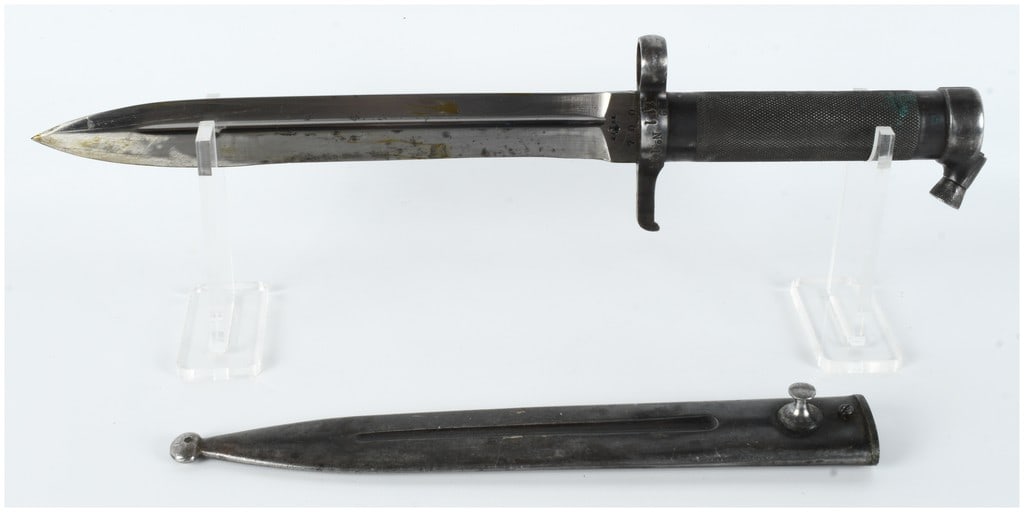 Swedish Model 1896 Mauser Knife Bayonet and Scabbard by Eskilstuna Jernmanufaktur AB: This is a Swedish Model 1896 knife bayonet, a standard-issue edged weapon for the Swedish Mauser rifle. The bayonet is constructed entirely of steel. The blade features a knife profile with a central 