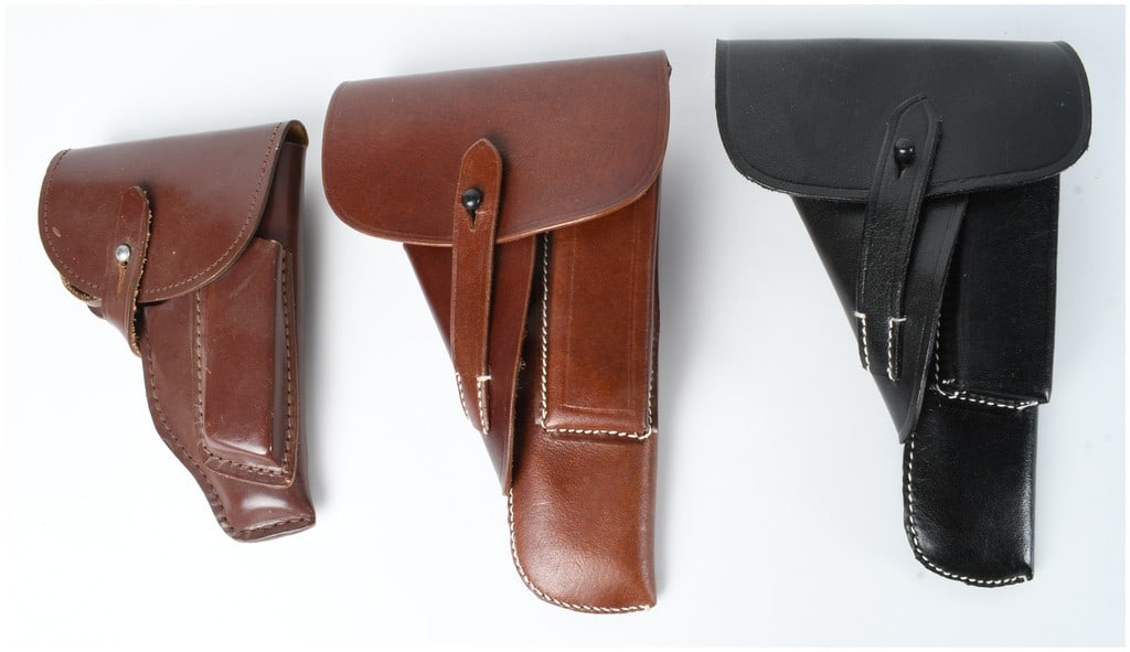 A Trio of German Style Leather Pistol Holsters: This lot features three leather pistol holsters in patterns used for German service and pocket sidearms, specifically the Walther P38 and 7.65mm pistols such as the Walther PPK. The collection include