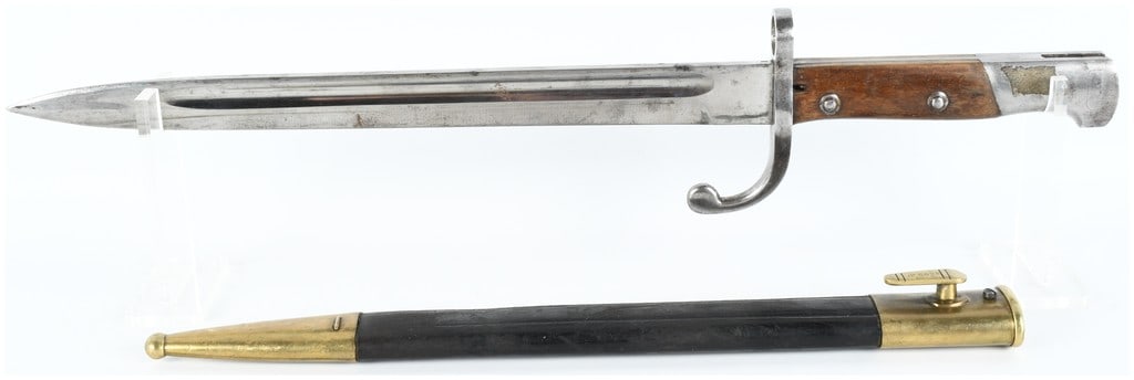 Imperial German Model 1871/84 Bayonet with Unit Markings and Scabbard: This Imperial German Model 1871/84 knife bayonet is accompanied by its original leather and brass scabbard. The straight, single-edged steel blade features a rounded tip and a deep fuller on both side