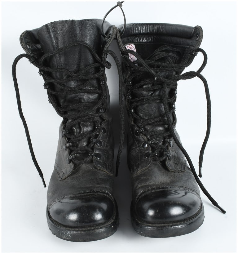 A Pair of Corcoran Black Leather 10-Inch Field Jump Boots Size 9D: A pair of black leather combat boots manufactured by Corcoran in the classic jump boot silhouette. The boots are constructed from full-grain black leather with a 10-inch high-cut design featuring a pa