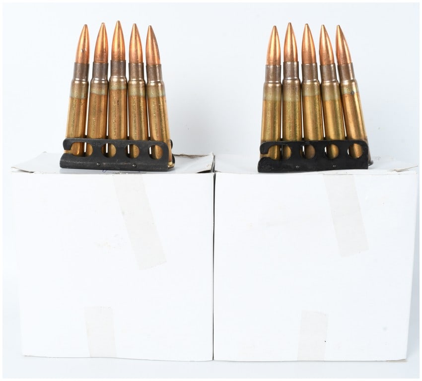 A Lot of 85 Rounds of .303 British Ammunition on Charger Clips: This lot consists of a collection of 85 rounds of .303 British caliber ammunition, organized and held on steel charger clips. The cartridges are constructed with brass casings and feature copper-jacke
