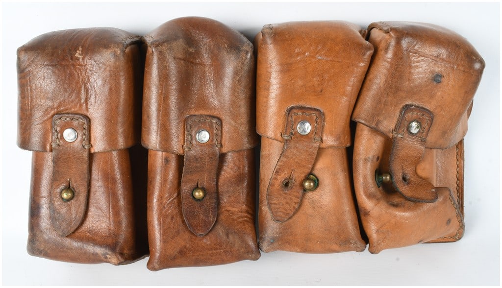 A Pair of Yugoslavian Pattern Two-Cell Leather Ammunition Pouches: A pair of two-cell military ammunition pouches constructed from heavy brown-dyed leather. Based on visual characteristics and strong market consensus, these items are identified as Yugoslavian