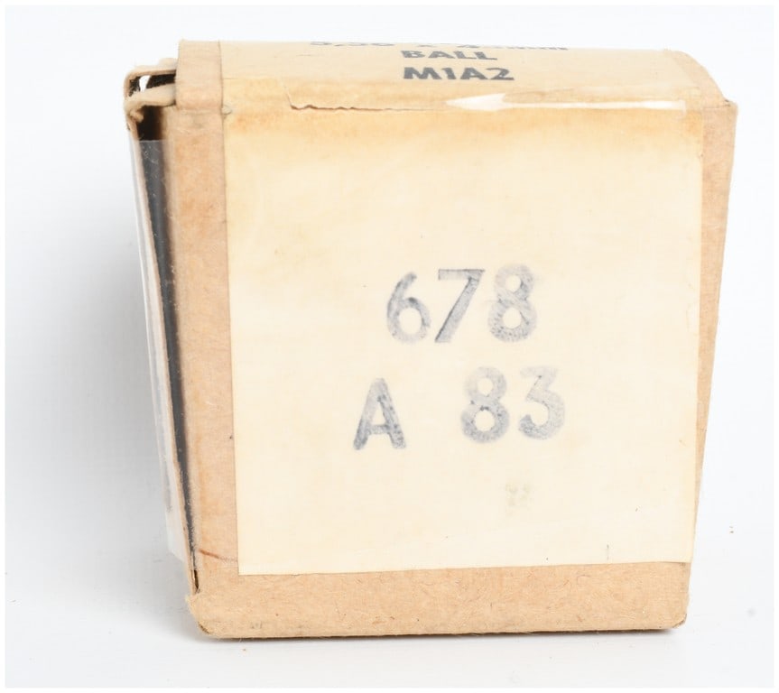 A Lot of 30 Rounds 5.56x45mm Ball M1A2 Ammunition 1983: This lot comprises a single cardboard box containing 30 rounds of 5.56x45mm ball ammunition, designated as M1A2. The cartridges are contained in a plain tan cardboard box with a white paper label.
