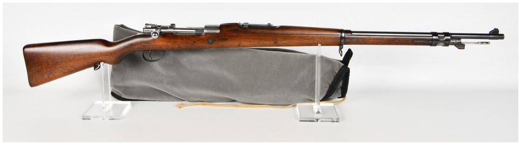 DWM Mauser Modelo Argentino 1909 Bolt Action Rifle 7.65x53mm with 29 Inch Barrel: This is an Argentine Mauser Modelo 1909 bolt-action service rifle chambered in 7.65x53mm caliber, produced by Deutsche Waffen-und Munitionsfabriken in Berlin. It features a standard pattern barrel equ
