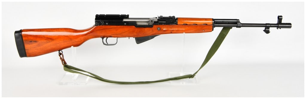 Norinco Type 56 SKS Semi-Automatic Rifle 7.62x39mm with 20 Inch Barrel: This Chinese Norinco Type 56 semi-automatic rifle is chambered in 7.62x39mm and is configured with a 20 inch barrel. The rifle features a blued steel finish on the receiver and barrel, accented by a b
