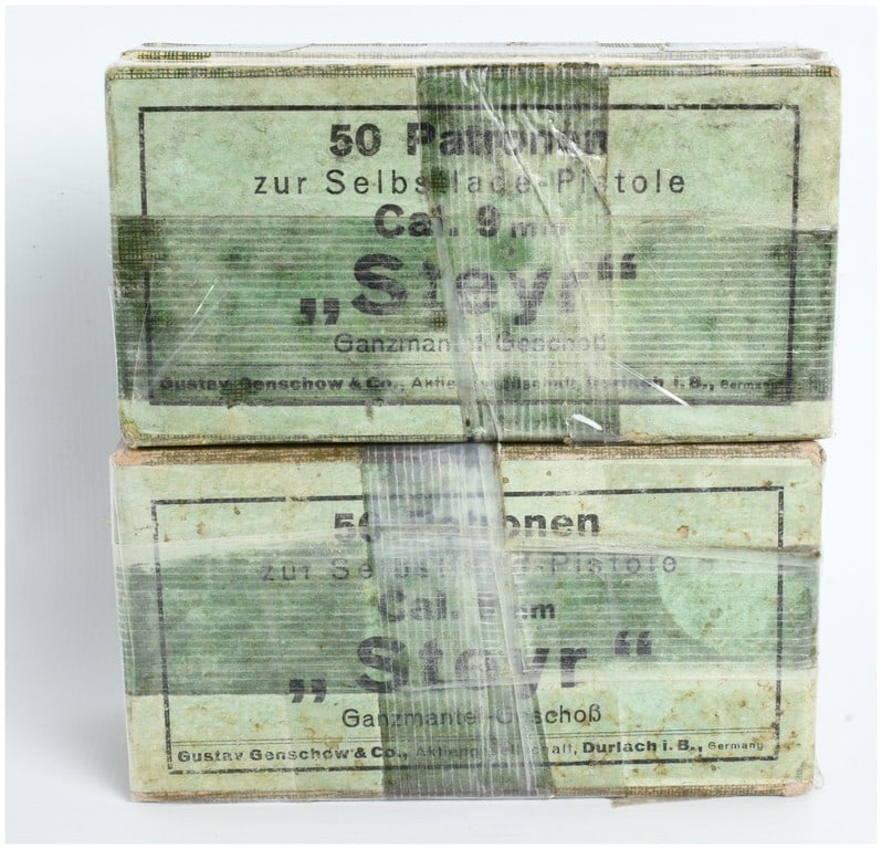 A Lot of 100 Rounds Gustav Genschow and Co. 9mm Steyr Pistol Ammunition: This lot consists of 100 rounds of vintage 9mm Steyr ammunition manufactured by Gustav Genschow and Co., marked with the GECO trademark. The ammunition is contained in two original green-tinted cardbo