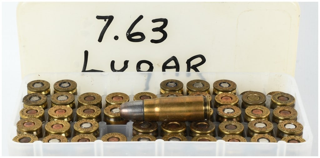 A Lot of 47 Rounds of Mixed 7.63 Mauser and .30 Luger Ammunition: This lot consists of 47 rounds of assorted centerfire pistol ammunition presented in a white plastic 50-round storage tray with a matching lid. The majority of the cartridges are bottlenecked 7.63mm M