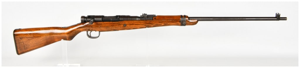 Nagoya Arsenal Arisaka Type 99 Bolt Action Rifle 7.7x58mm: This Japanese Arisaka Type 99 bolt-action rifle, produced at the Nagoya Arsenal, is chambered in 7.7x58mm and features a modified sporterized configuration. The receiver bridge displays three incised 