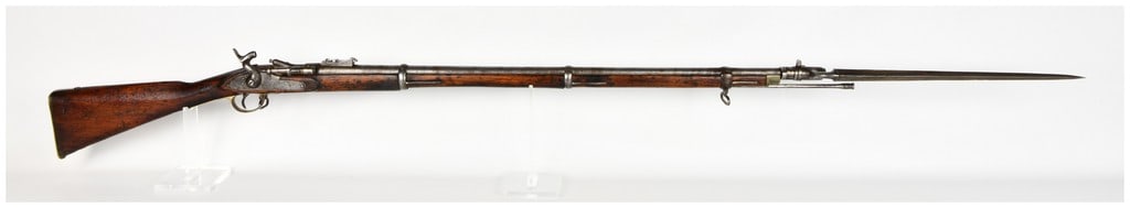 Nepalese Snider-Enfield Pattern Breech-Loading Rifle with Socket Bayonet: This is a Nepalese-manufactured breech-loading percussion rifle produced in the pattern of the British Snider-Enfield. It features the characteristic side-swinging breech block mechanism used to conve