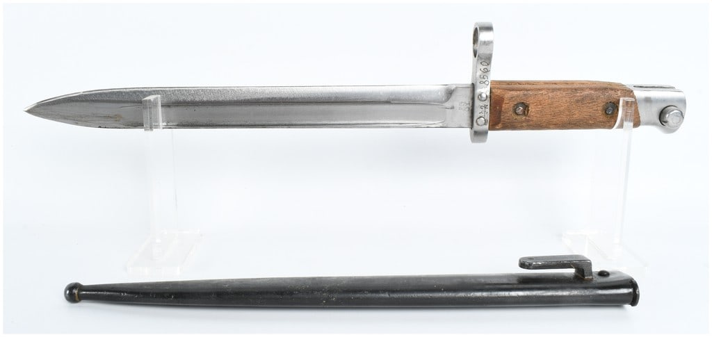Hungarian Model 1935 Mannlicher Rifle Bayonet and Scabbard: This is a Hungarian Model 1935 (M35) Mannlicher rifle bayonet, produced for the Hungarian Royal Army. The bayonet features a single-edged, bright-finished steel blade with a deep longitudinal fuller o