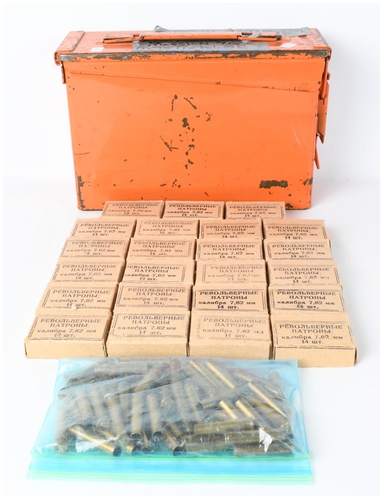 A Lot of 320 Rounds of Russian 7.62 Nagant Pistol Ammunition and 50 Empty Brass Casings: This lot comprises 320 rounds of Russian 7.62x38mmR caliber ammunition intended for use in the Nagant M1895 revolver. The ammunition is packaged in twenty-three cardboard boxes, each bearing markings