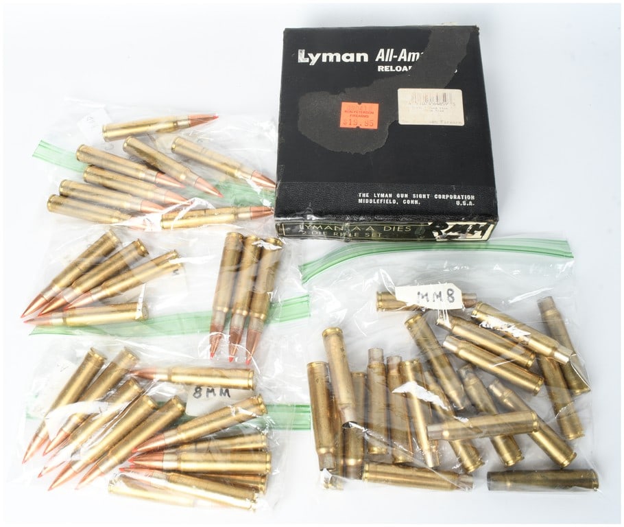 Lyman All-American 2-Die Rifle Set with 27 Live Rounds and 21 Empty Brass Casings 8mm Mauser: This lot features a Lyman All-American two-die rifle reloading set designed for the 8x57 Mauser cartridge, accompanied by a collection of ammunition components. The set is housed in its original black