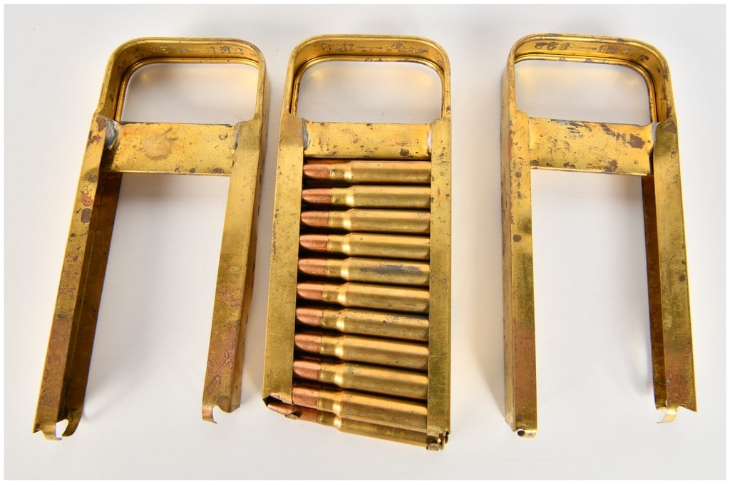 Three Italian Breda Modello 30 Machine Gun Charger Clips with Twenty 6.5mm Rounds: A trio of Italian military charger clips designed for the Breda Modello 30 light machine gun. These hopper-style clips are manufactured from brass or brass-plated steel in a distinctive U-shaped form.