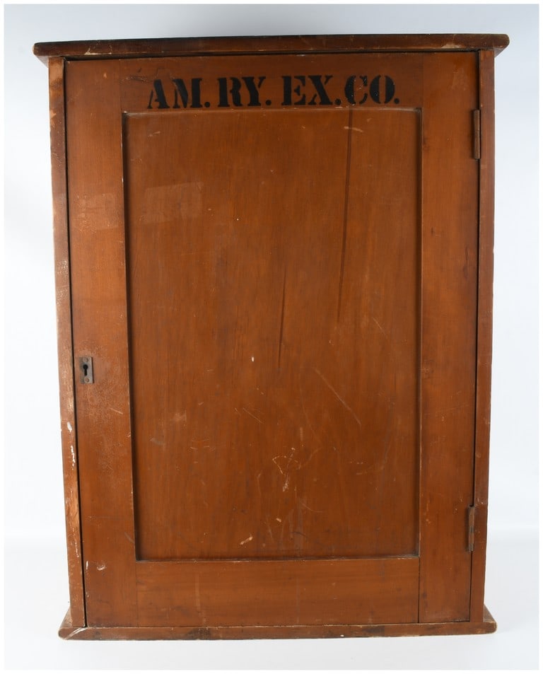 American Railway Express Company Wooden Office Sorting Cabinet: This one-piece industrial office sorting cabinet was manufactured for the American Railway Express Company. It is constructed of hardwood with a medium brown stained finish. The exterior features a si