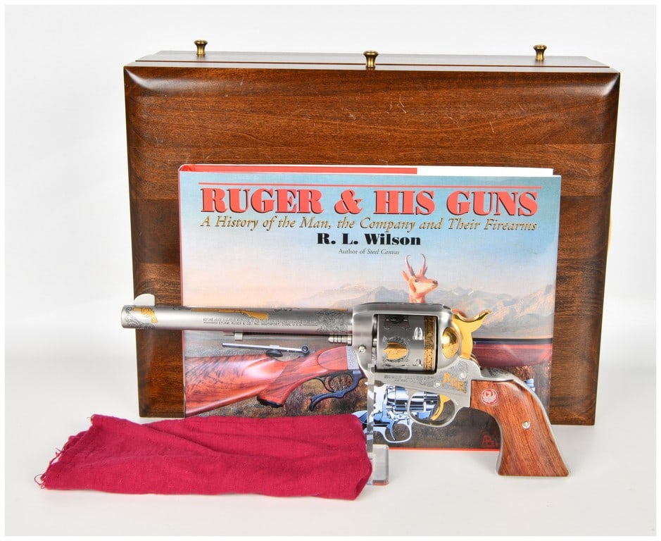 Ruger Vaquero Single Action Revolver .44 Magnum with 7.5 Inch Barrel: This lot features a single Ruger Vaquero single action revolver chambered in .44 Magnum, presented as a highly decorated ?Ruger & His Guns? commemorative edition by America Remembers. The firearm is c