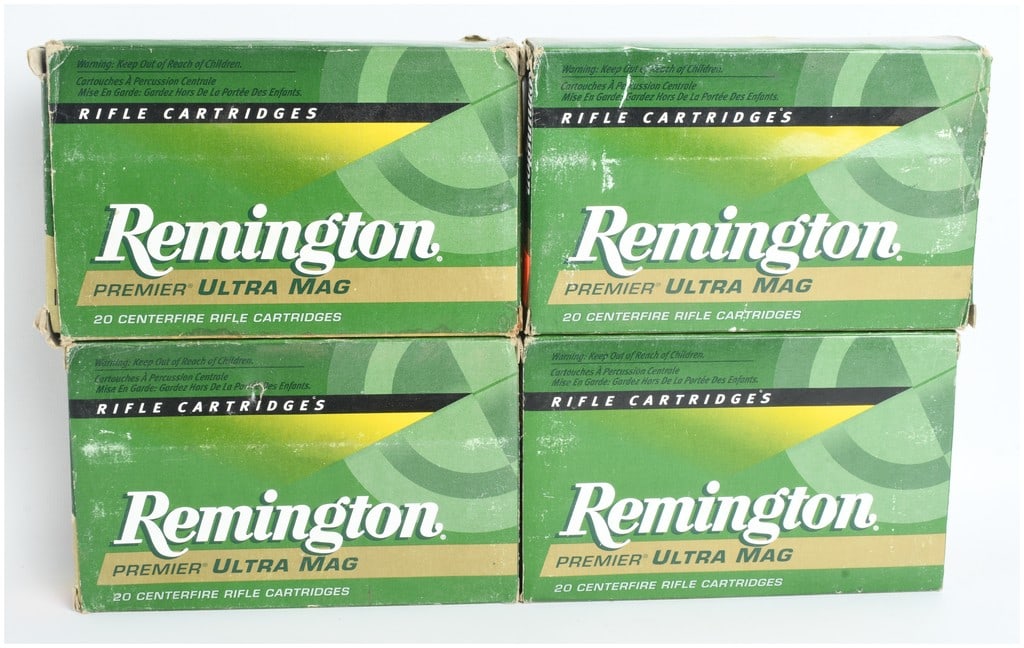 A Lot of Four Boxes of Remington Premier Ultra Mag Ammunition .375 Remington Ultra Mag: This lot features a collection of four boxes of Remington Premier Ultra Mag centerfire rifle ammunition chambered in .375 Remington Ultra Mag. The assortment includes 65 live rounds and 15 empty brass