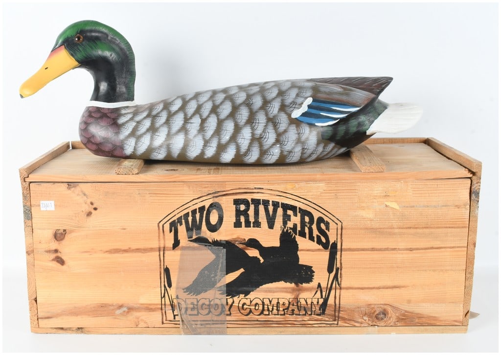 Two Rivers Decoy Company Mallard Drake Wood Decoy and Branded Wooden Crate: This lot features a decorative mallard drake decoy and an accompanying branded wooden crate. The decoy is constructed of carved wood with inset glass-style eyes. The hand-painted finish includes an ir